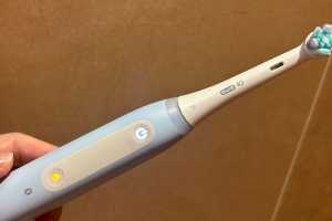 The button on my Oral-B iO is glowing yellow. How do I fix it?